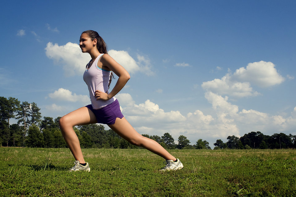 15250-a-young-woman-stretching-outdoors-before-exercising-pv