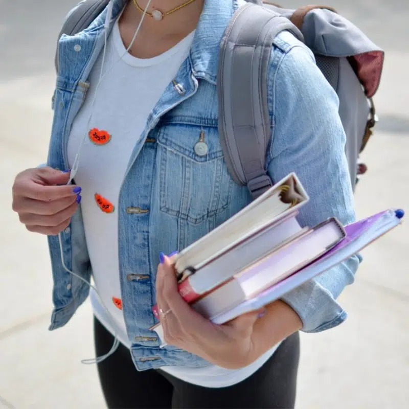 girl holding books