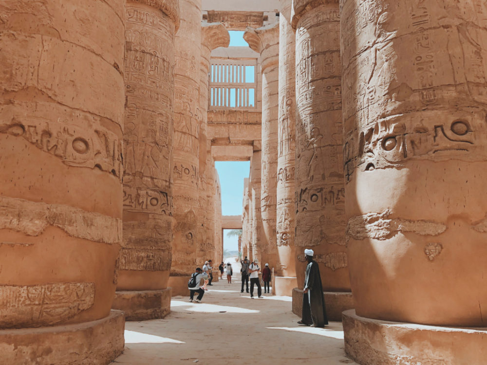 people standing near Egypt pillars