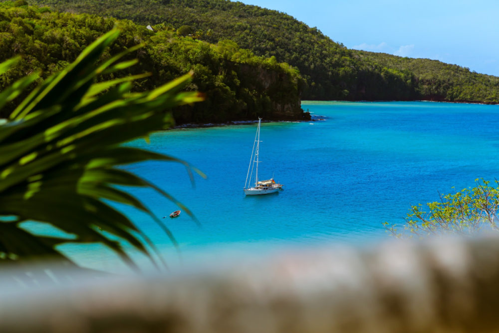 blue waters and a sail boat