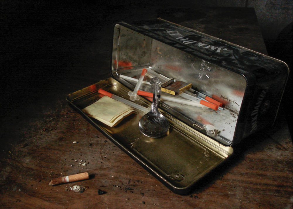 spoon and syringes inside metal box