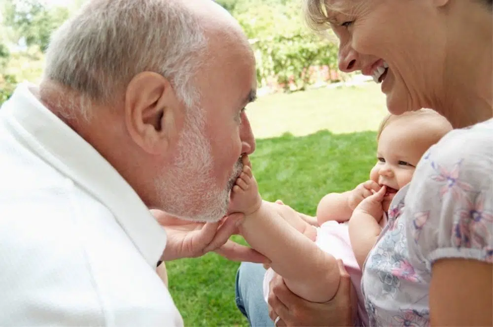 man and woman holding a baby