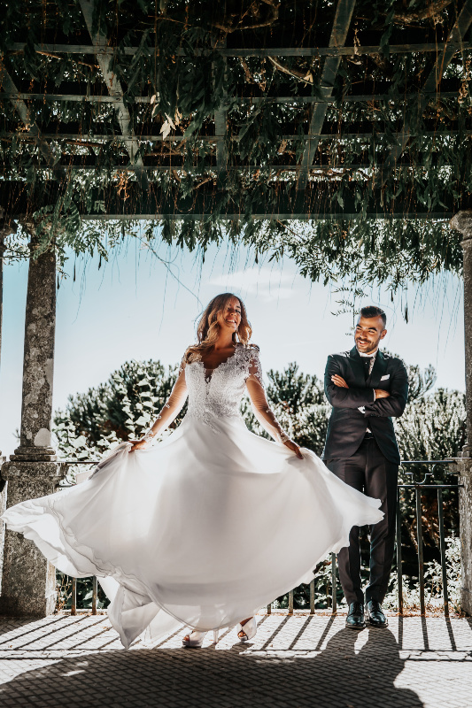 woman wearing white dress beside man wearing formal suit under 