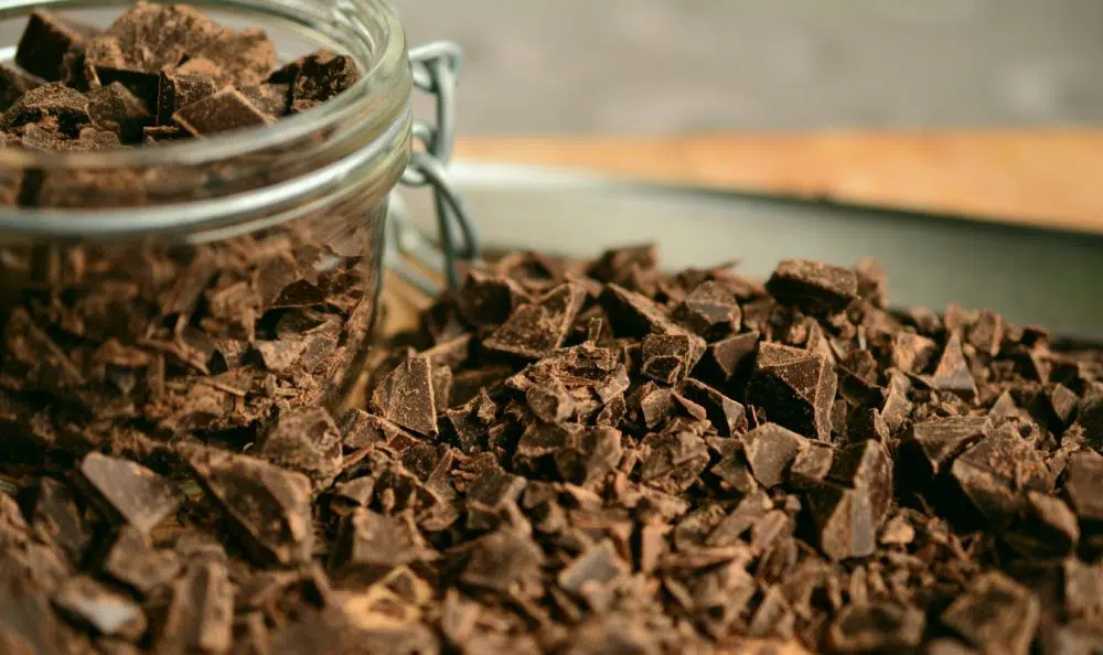 chunks of chocolate in jar and on table