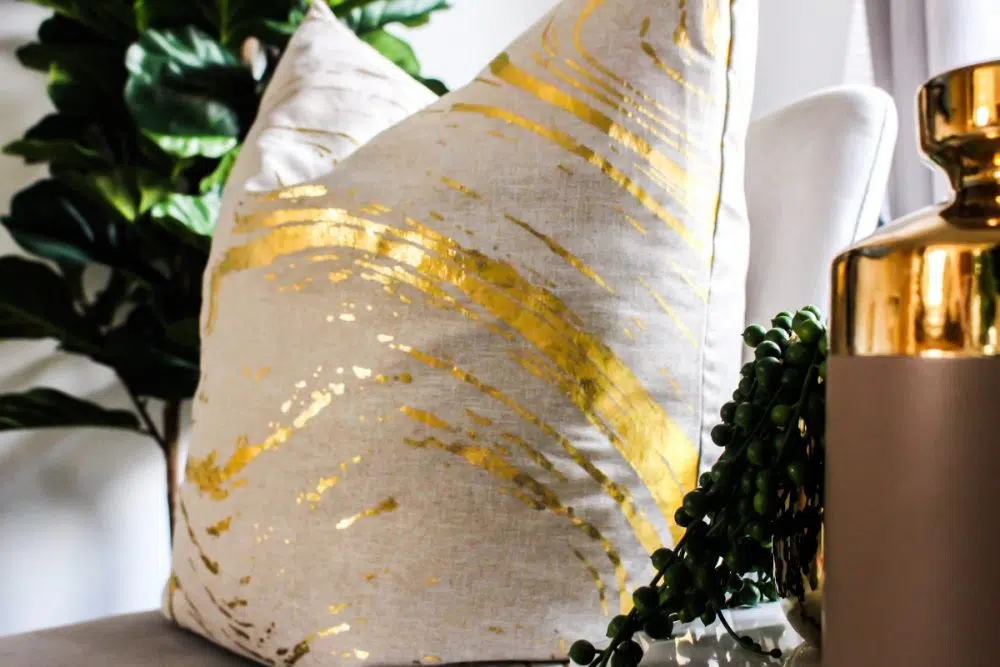 white pillow with gold stripe