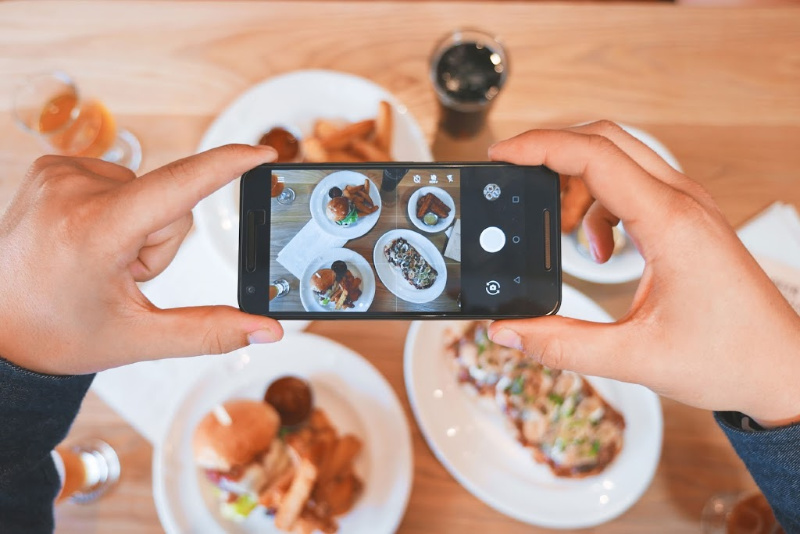 person taking picture of food