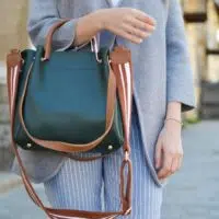 woman holding a black purse