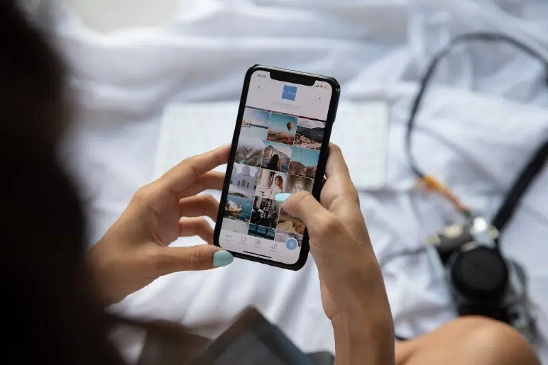 person sitting on bed playing with phone