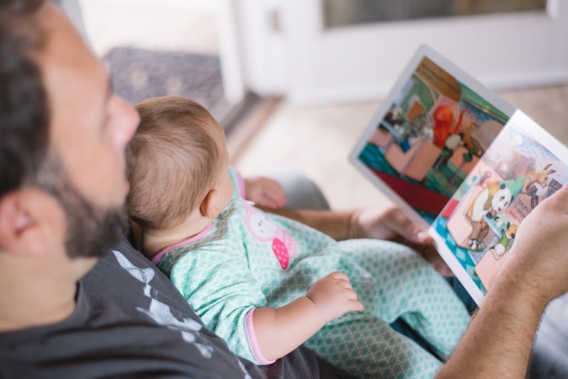 father reading to child