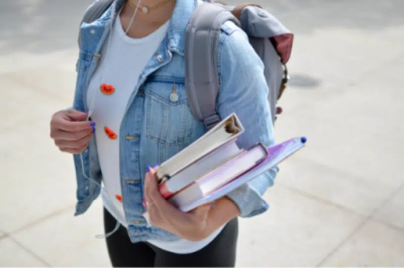 girl walking with books