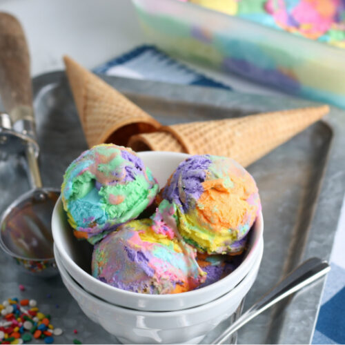 Rainbow ice cream in a bowl with cones