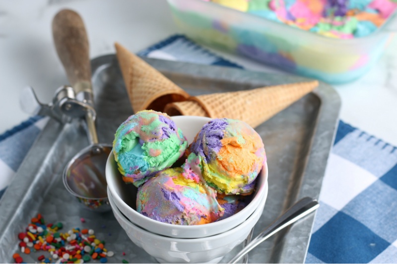 Rainbow ice cream in a bowl with cones