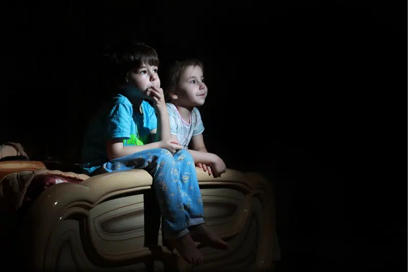Children watching TV in the dark