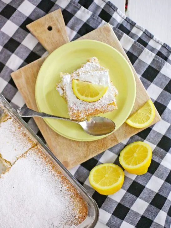 A shot of the final product, Homemade Lemon Bars, dusted with powdered sugar and cut into squares.