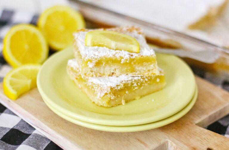 A shot of the final product, Homemade Lemon Bars, dusted with powdered sugar and cut into squares.
