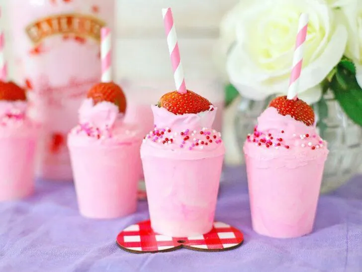 Valentine's Day strawberry milkshakes are a delicious and romantic treat perfect for celebrating love. Served in cocoa cups, these indulgent beverages are made with Bailey's Strawberry and Cream, creating a
