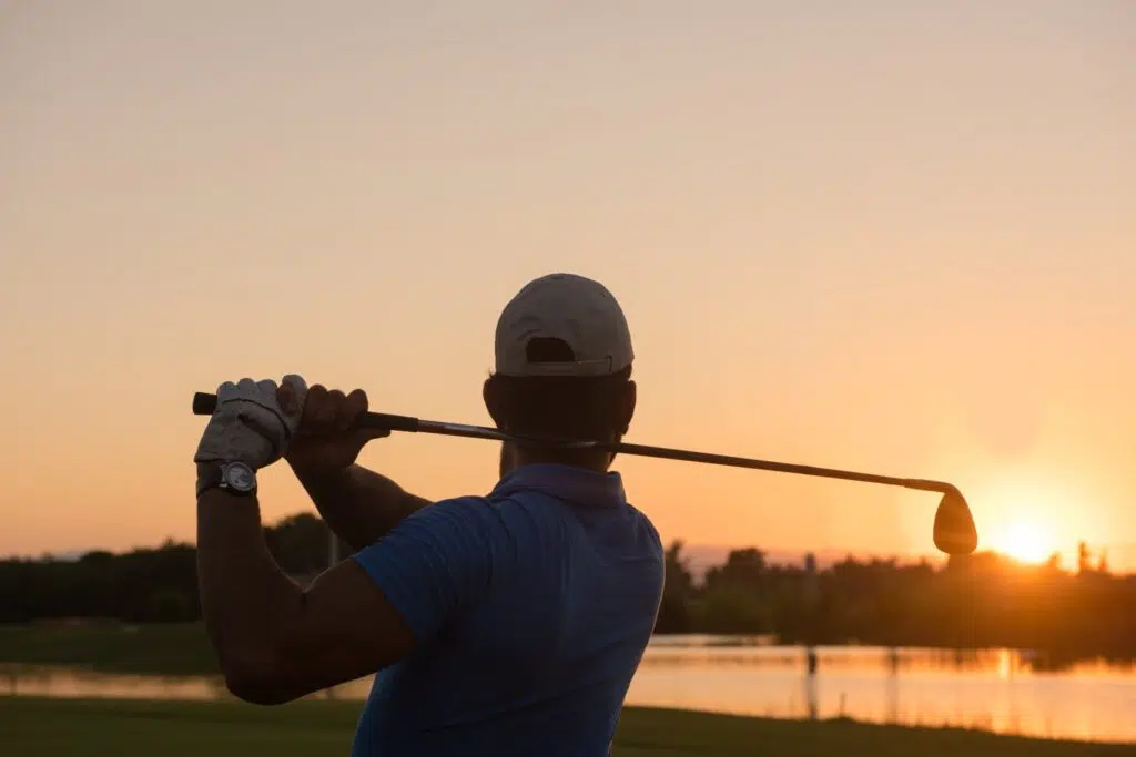 golfing at sunset