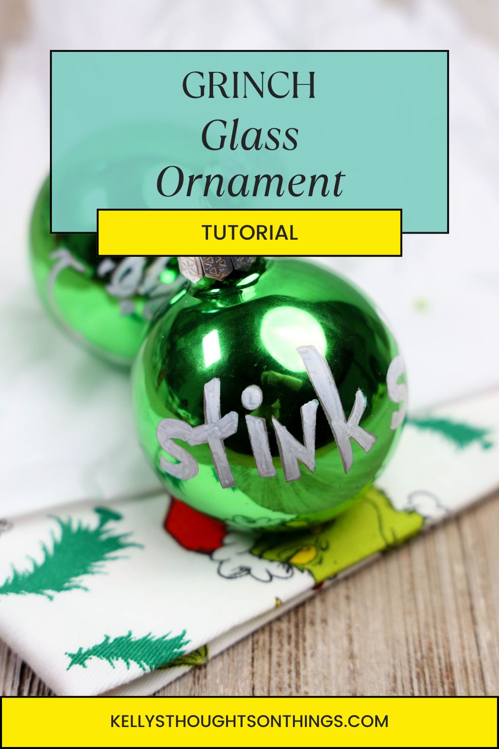 Green glass ornament with "stink" written on it, reminiscent of a Grinch glass ornament, placed on a holiday-themed cloth. Tutorial header text is visible above.