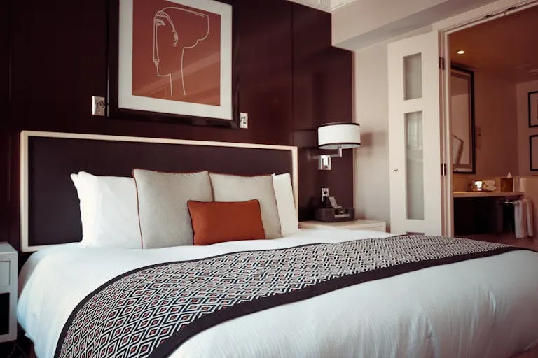 Cozy and modern hotel bedroom interior with elegant decor and soft lighting.